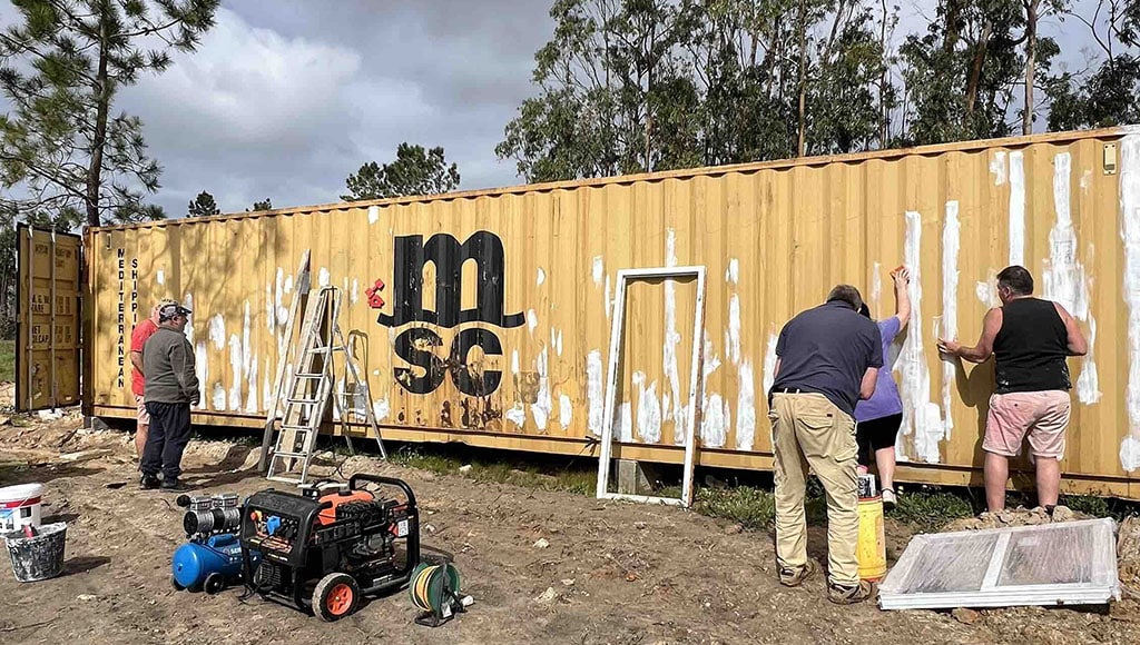 The container before: applying anti-rust paint and planning the first cuts