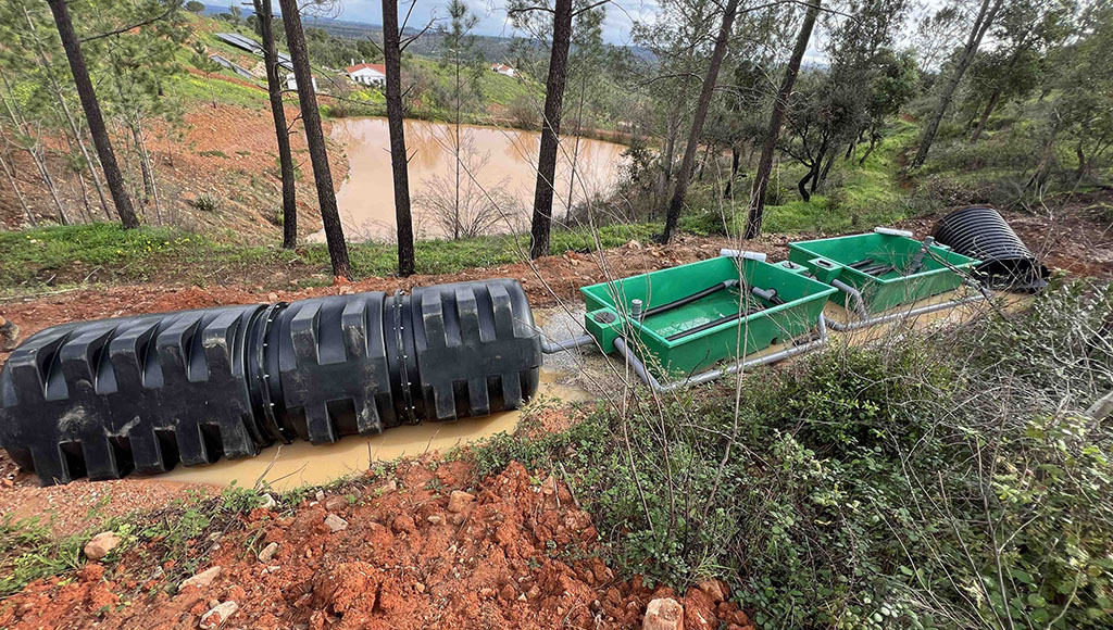The ruined fossa reed-bed and tank water treatment system after the flood and landslide