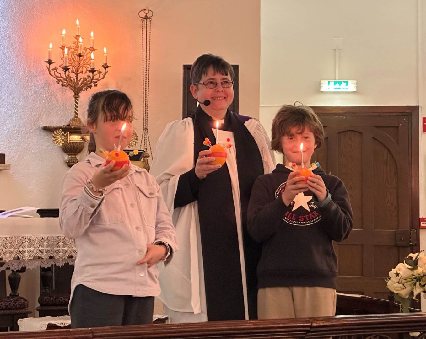 Revd Carla with Martha and Joshua Jordan at the Carol Service|Giving gifts to the clients of the Vale Silves Community Centre|Christmas gifts donated via St Vincent’s Boliqueime congregation