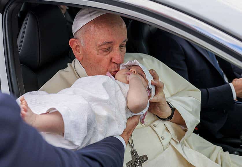 Pope Francis kisses a baby during the route between Belem Palace and Centro Cultural de Belem after a meeting with Portugal's President Marcelo Rebelo de Sousa (not pictured) in Lisbon, Portugal, 02 August 2023. The Pontiff will be in Portugal on the occasion of World Youth Day (WYD), one of the main events of the Church that gathers the Pope with youngsters from around the world, that takes place until 06 August. JOSE SENA GOULAO/LUSA/POOL