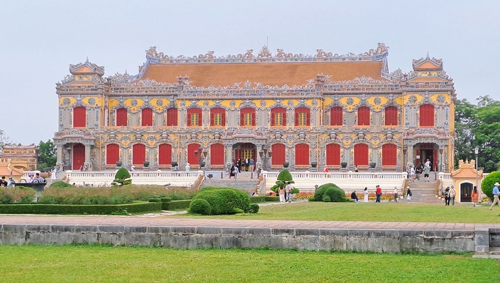 The ornate main Palace Building looks a bit like a weding cake|Hanoi's world famous Railway Street|Picturesque garden at the Temple of Literature|Proud mother and student at Temple of Literature|Old Quarter café, perfect for an Egg Coffee|Vietnam has 65 million scooters!|Entrance to Ninh Binh, Vietnam's ancient capital|Small sampans travel along the beautiful river at Tam Coc|The unique scenery at Ha Long Bay|Shrine at the splendid Thien Mu Pagoda|Visitors dress up as members of the former royal family