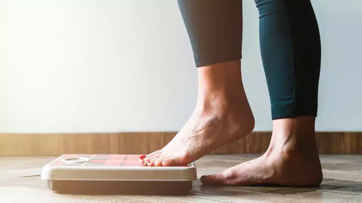 person stepping onto scales