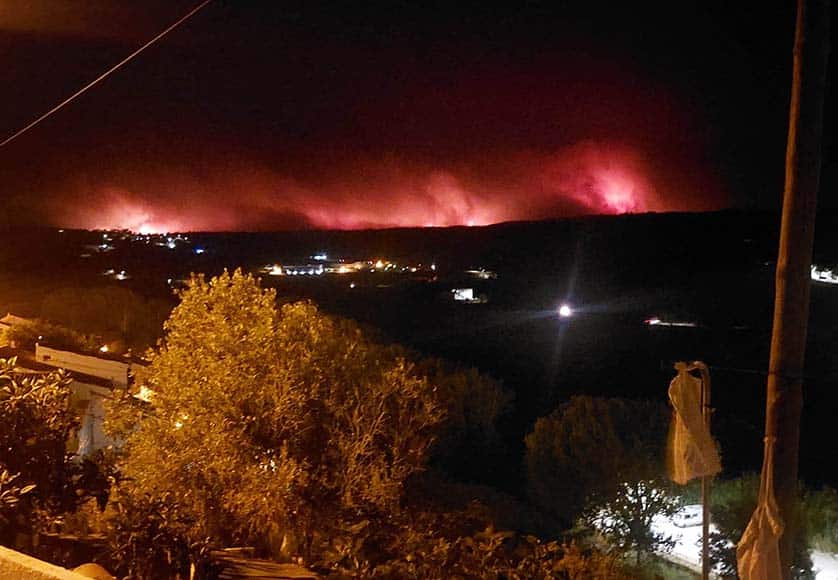 View last night of skyline looking north from Aljezur|helicopter putting out fire|wildfire in Portugal