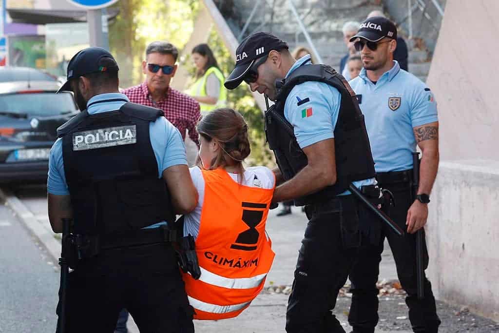 A climate activist being removed by PSP officers during a protest on the Segunda Circular Highway in Lisbon on October 3