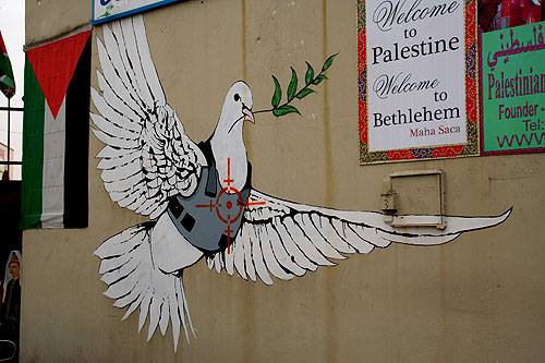 Famous Banksy image on the West Bank where the illusive artist has been painting for a number of years (https://www.thenationalnews.com/arts-culture/art/banksy-in-palestine-a-look-at-the-street-artist-s-work-in-gaza-and-the-west-bank-1.1031618)