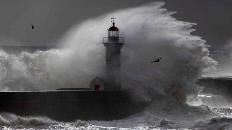 Lighthouse being hit by large waves