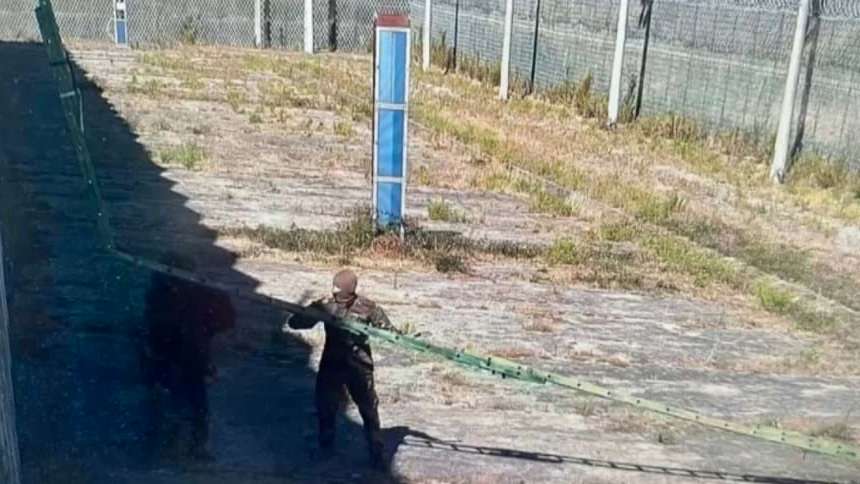 Surveillance cameras (not being watched in real time) captured the mass escape. Here, two men in military fatigues can be seen putting the ladder in place for the five prisoners to shimmy down
