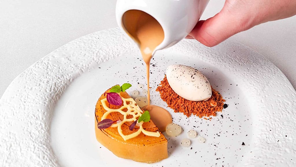 apple tarte tatin with croissant ice cream, mountain pine and caramel sauce