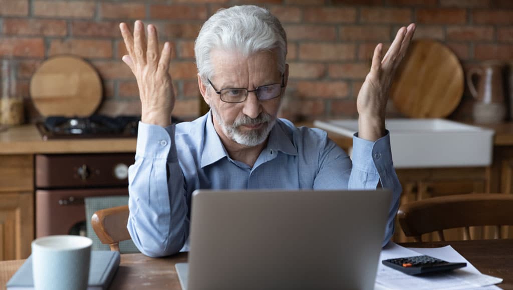 Annoyed worried aged man pensioner sit by laptop unable to make utility bill loan payment online has question how to use app need help. Stressed old grandpa confused with unexpected debt on pc screen|Lisbon, Portugal at Rossio Square.|Word Tax 2024 on the calculator on documents.Income Statement. paying the tax rate. Taxation, taxes burden.Business and tax concept.