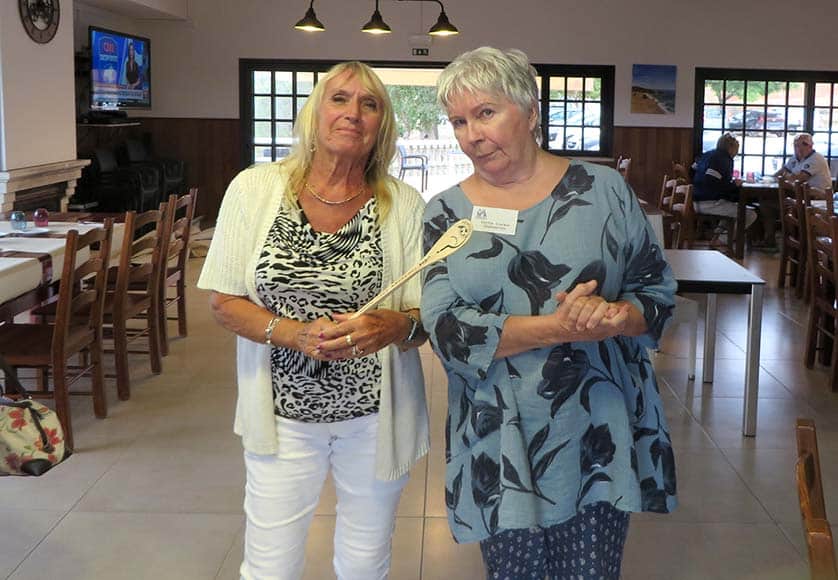 The CASA chairperson (right) presents the driver of the losing team with the coveted Wooden Spoon
