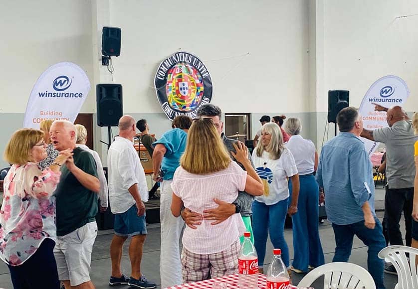 Revellers enjoy the band|Pictured: Richard Allen (left) with Joe Mac of Wild Flowers at Communities Unite|Wild Flowers rock out|Event poster