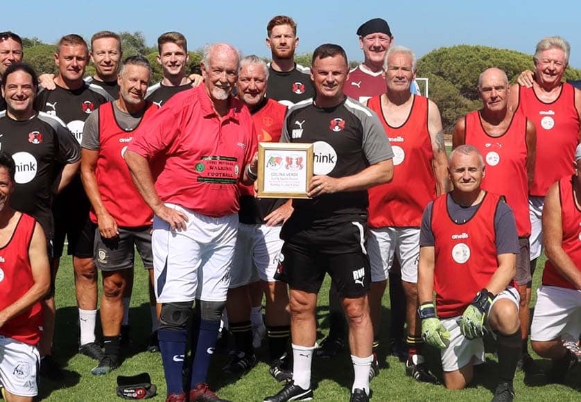 EAWF (red) and Leyton Orient (black) with Richie Wellens, manager Leyton Orient, being presented with a commemorative plaque.|Real Betis (blue & green-white stripes) and EAWF (black & green-black stripes)