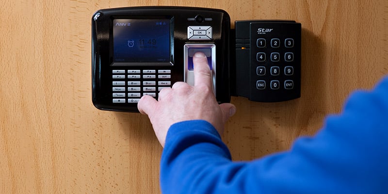 A man's hand entering an access code to get into his storage unit with his belongings.|A man's hand entering an access code to get into his storage unit with his belongings.
