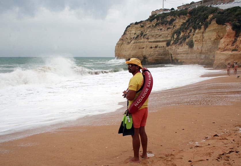 Eric, one of the two lifeguards while on duty with the strong waves in the background