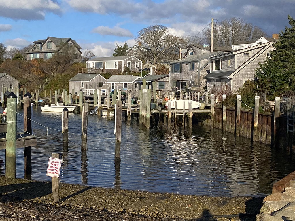 Menemsha harbor, formerly a major whaling station but still a departure point for local fishermen|A typical Martha’s Vineyard harbor scene, this one in Vineyard Havejn, a town of about 2,000 but the car ferry terminus from Woods Hole on Cape Cod|Most of Martha’s Vineyard is very rural. This row of mailboxes is quintessentially New England|This woodsy trail leads to Lambert Beach, on the north shore. It is late Autumn, but there is still quite a lot of color in the remaining leaves|Lambert Beach is typical of the large number of very sandy beaches on the island|A typical house, right on the water, with its dock|East Chop Light is known locally as Telegraph Hill Light. The present 40 ft tall tower was erected in 1878 and, although open to the public, the lighthouse is still active today|A late season maple brings a tongue of color|This little house is one of about 300 Victorian cottages built in the 1800s in Oak Bluffs as part of a Methodist retreat. In season, they are all occupied and there is a flurry of activity at the “Campground”|A row of lovely houses on a quiet, secluded street in Oak Bluffs|Edgartown Harbor Light marks the entrance to Edgartown and Katama Bay. It was built in 1939, replacing the original 1828 structure. It is on the National Register of Historic Places and is open to the public in season.|Edgartown Harbor|This is the Orange Peel Bakery cash register|This tiny structure is the Orange Peel Bakery, a native-owned bakery based on the Wampanoag lands of Aquinnah. It is run by Juli Vanderhoop, who bakes every day in a wood-fired stone oven and leaves her delicious edibles in the unstaffed little house. Payment is on the honor system|The Gay Head Light was authorized by the US Congress in 1798 and was built shortly thereafter at the tip of Aquinnah on Wampanoag land|Menemsha is a small fishing village in the town of Chilmark. It was the shooting background for the fictional “Amity Island” of Spielberg’s 1974 film “Jaws”|5088 – Sailing is a major activity on Martha’s Vineyard, but in November the sails are all furled