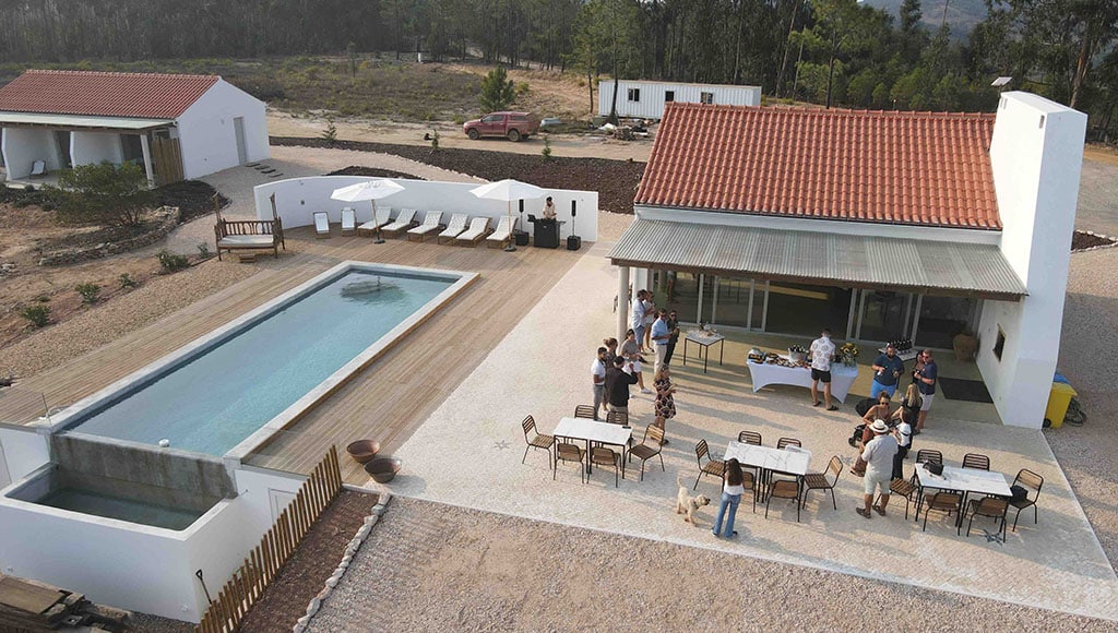 Time tasting: we’ve already hosted a few events … mostly centred around wine|Wines of Odemira: Diogo Ribeiro runs wine tastings at the Nascedios Winery in Fornalhas Novas|Cheers: Ole Martin Siem toasts the opening of his new Vicentino winery just down the road from us|Reedy and waiting: the water treatment plants are thriving|Shelving it: with thanks to Pedro for keeping everything level|Toasty: Simon the dog appreciates the handmade coffee tables and cork walls but prefers the underfloor heating|The new mantra: Pour it and they will come … hopefully|Winemakers: Ana Rita Bouça, Bernardo Cabral and Miguel Mimoso at the opening of Vicentino’s new winery|Rubbish views: one of the biggest problems is the ugly beaches nearby