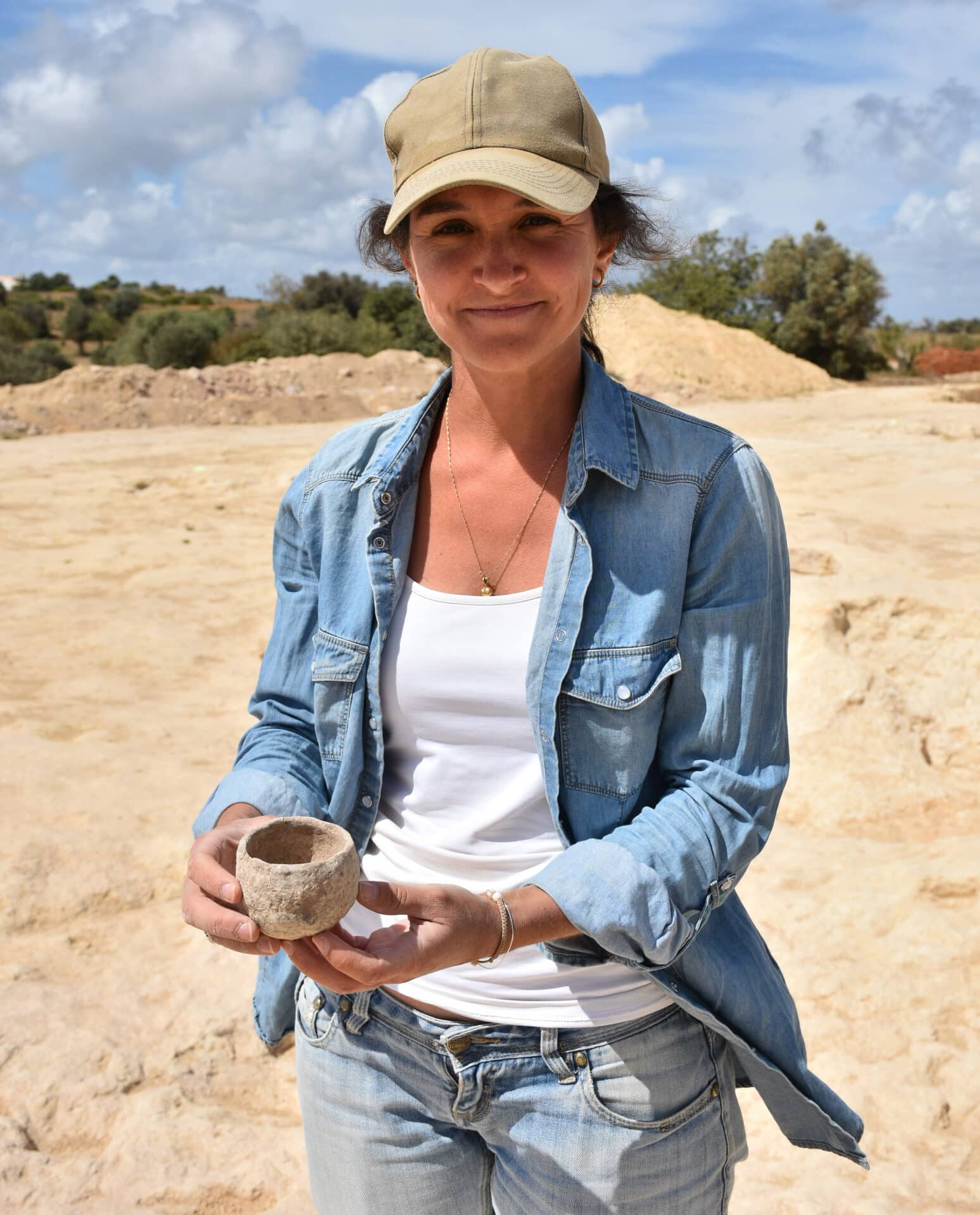 Archaeologist Catarina Furtado holding a Chalcolithic vase