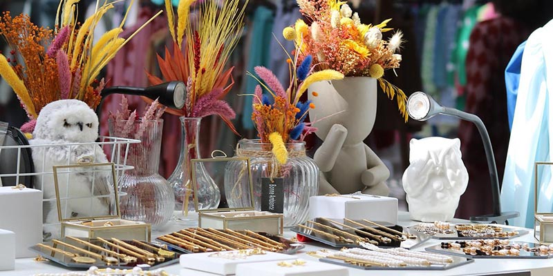 Photo of a stand at The Spot Market|||oman sitting on a bench at The Spot Market||
