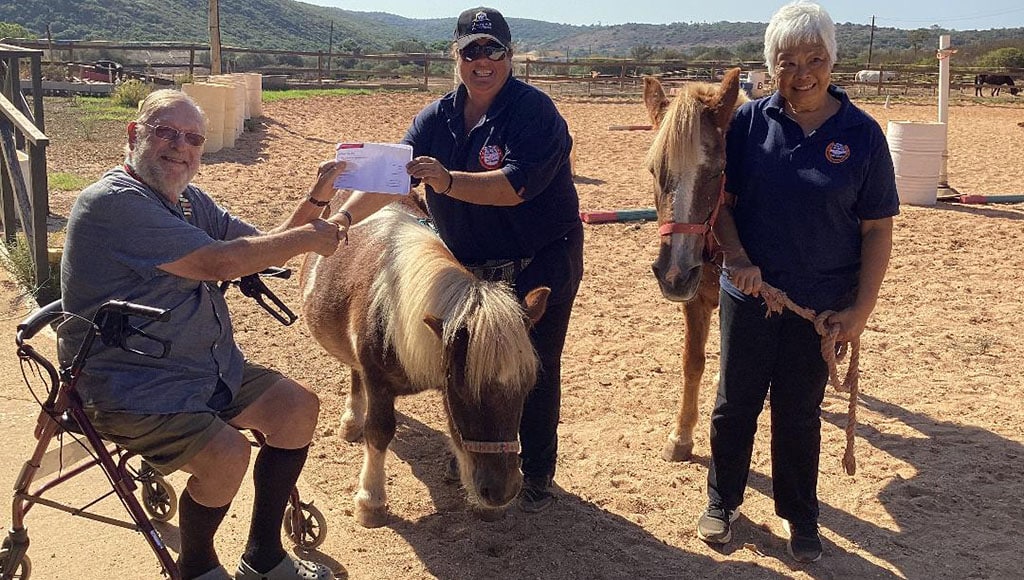 Algarve 41 Club Chairman, Michael Brown, presenting Riding for the Disabled with a cheque