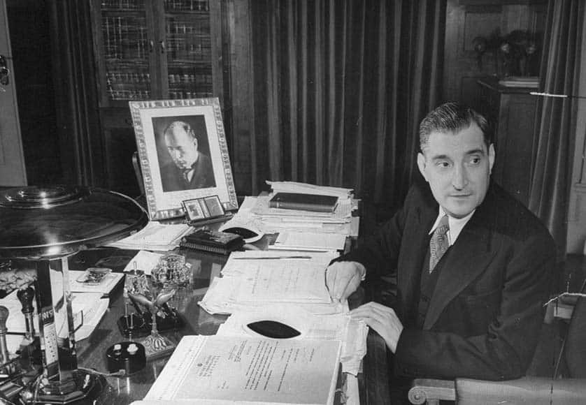 Salazar at his desk with a picture of Mussolini|1933 poster for New Constitution