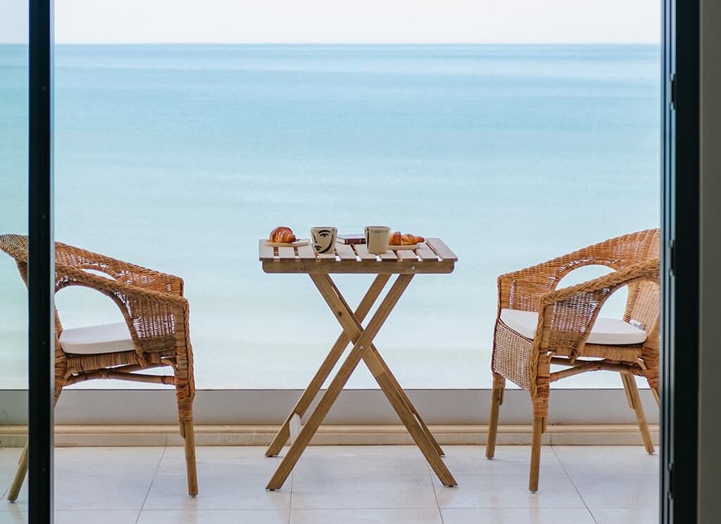 patio table and chairs with a sea view background