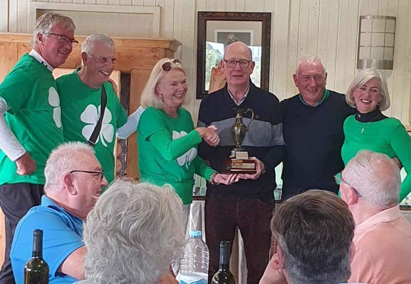 Jette James, accompanied by her friends, is presented with the Helen Cafolla Trophy by the Society chairman, Damian Clarke