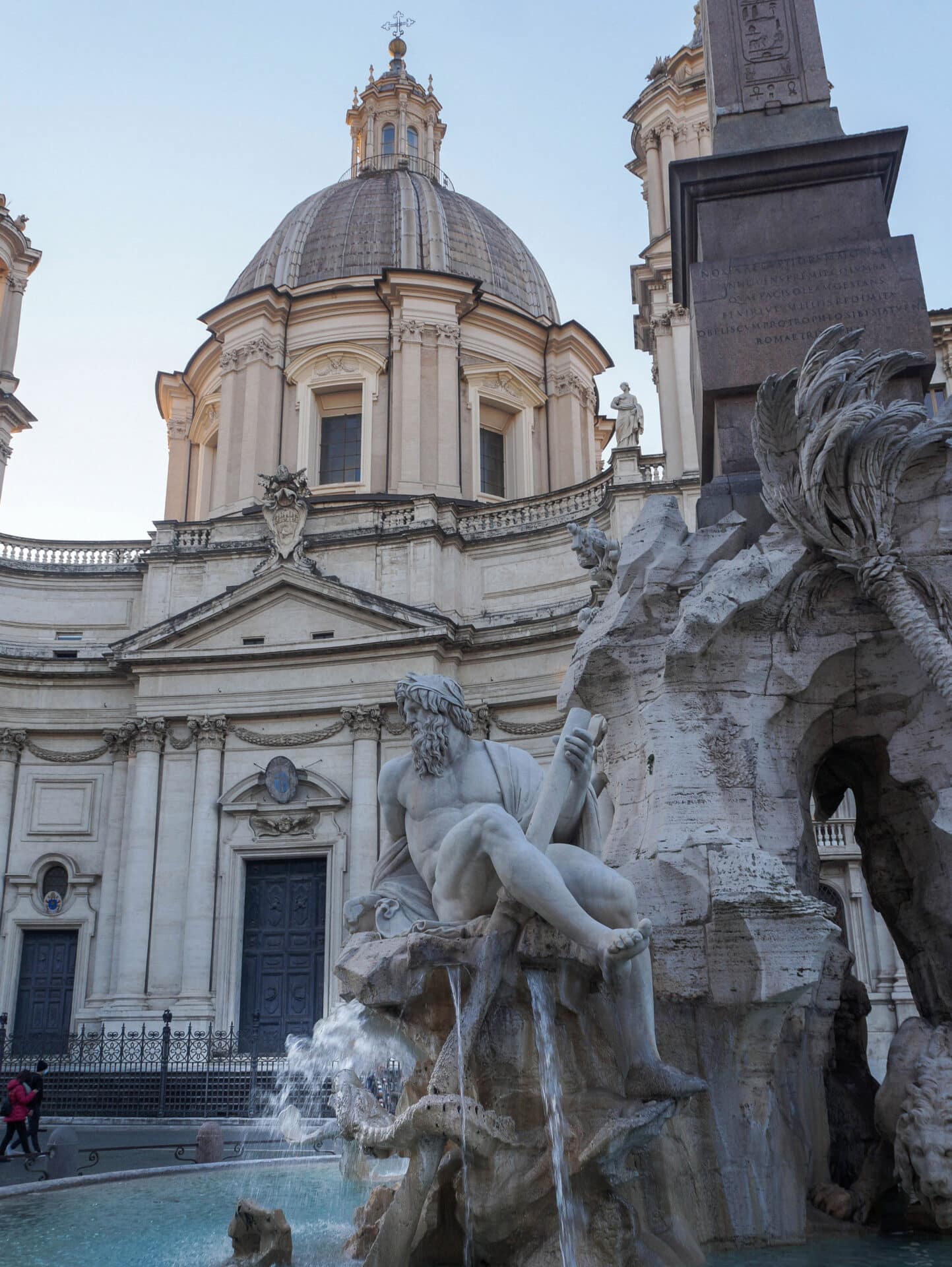 The Fountain of the Four Rivers and the church of Saint Agnes|The Ganges River god at Piazza Navona