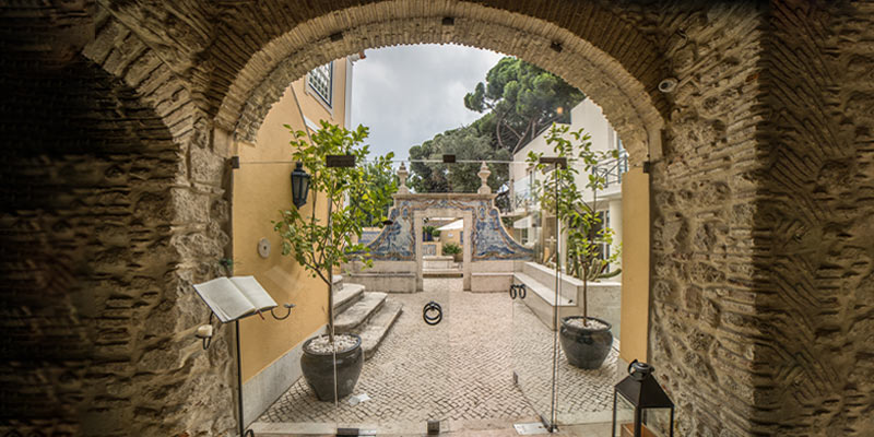 View of patio of the Solar do Castelo hotel located in a building that's part of Lisbon’s history|View of patio with a fountain of the Solar do Castelo hotel which located in a building that's part of Lisbon’s history
