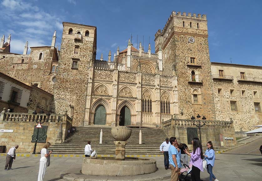 The façade of the Monastery of Saint Mary of Guadalupe, built during the 14th century|A view of the Mudéhar cloisters of the Guadalupe Monastery|The Marble Temple Roman ruins on the bank of the Valdecañas reservoir|A wonderful view of Toledo, looking across the Tajo River, with the cathedral on the left and the Alcázar on the right dominating the skyline|The Toledo cathedral|The Toledo Alcázar, site of an important siege when Nationalist Colonel Ituarte held the building against overwhelming Republican forces, and now a military museum|The Puente de Alcantara, spanning the Tagus River, a national cultural monument|Puerta del Sol, built in the late 14th century by the Knights Hospitaller. The medallion above the arch depicts Ildephonsus, Toledo’s patron saint|The Spanish gothic façade of the cathedral. The harmonious tower on the right is topped by a dome designed by El Greco’s son in the 17th century|The El Greco Museum|The beautiful Bodegas Martué Pago winery|From left: Linda and David Grindley, Poul Snorgaard, António Merino, the winemaker at Casa del Blanco, Helga and Larry Hampton, Henk and Loes Vooijs and Vibeke Snorgaard