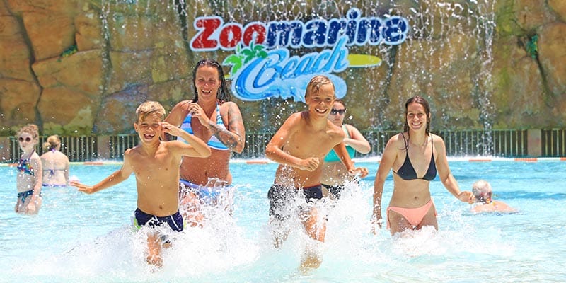 Family running out of the water in Zoomarine's beach where this year a butterflies garden was born