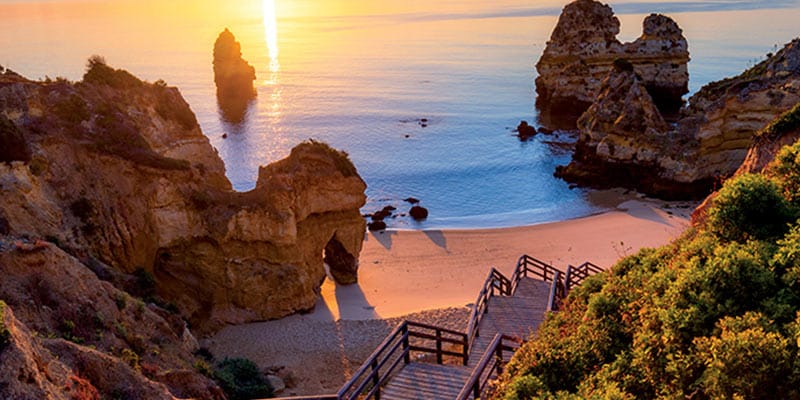 Photo of a beach in the Algarve region and one of the favourite places of expats living in Portugal|Photo of a small village in the Algarve