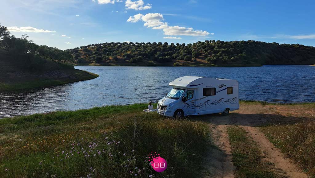 One of Caravans2rent's motor home parked by a lake|A family having a picnic in front of one of Caravans2rent's motor homes|caravans2rent-3-feb-2024