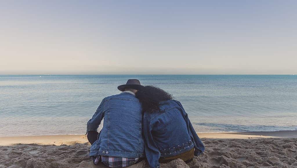 couple sat on the beach