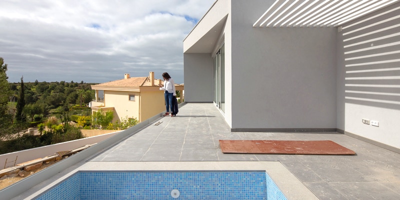 One of the architects of CORE Architects overseeing the final phase of construction of an energy-efficient house they were building in the Algarve