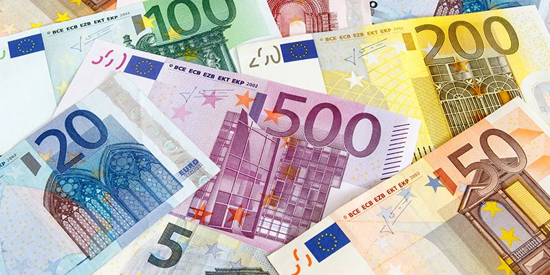 Different Euros bills scattered to simbolize currency transfers