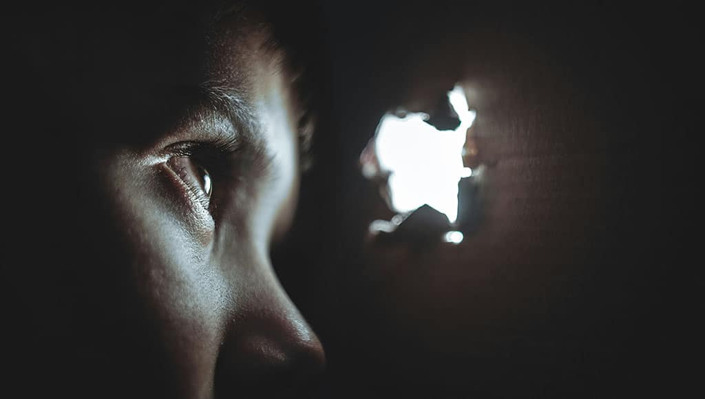child looking through hole