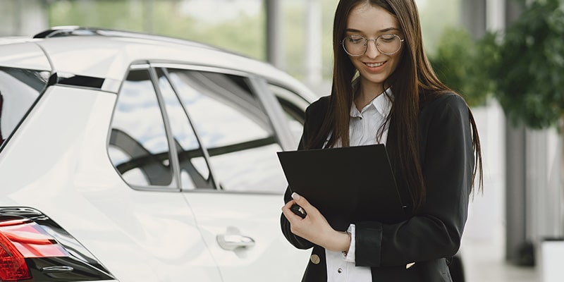Woman looking at vehicle documentation, the area docLagos works in