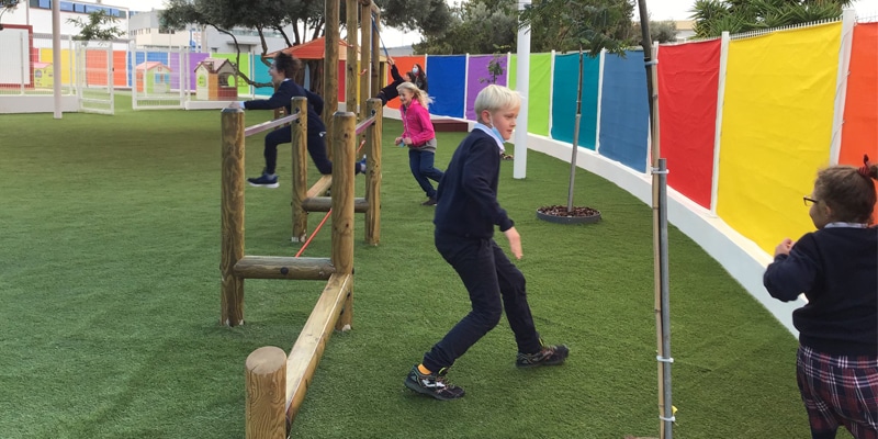 Students running on the playground at Eupheus International School