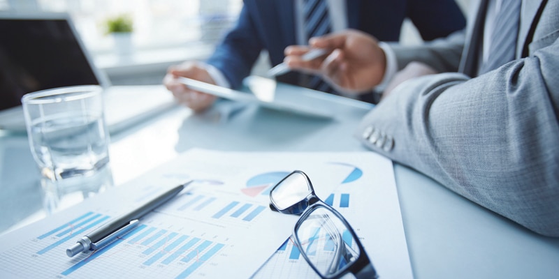 Two people analysing spread sheets and graphs at eurofinesco