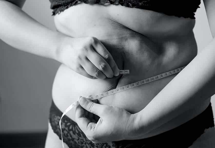 woman with tape measure around waist