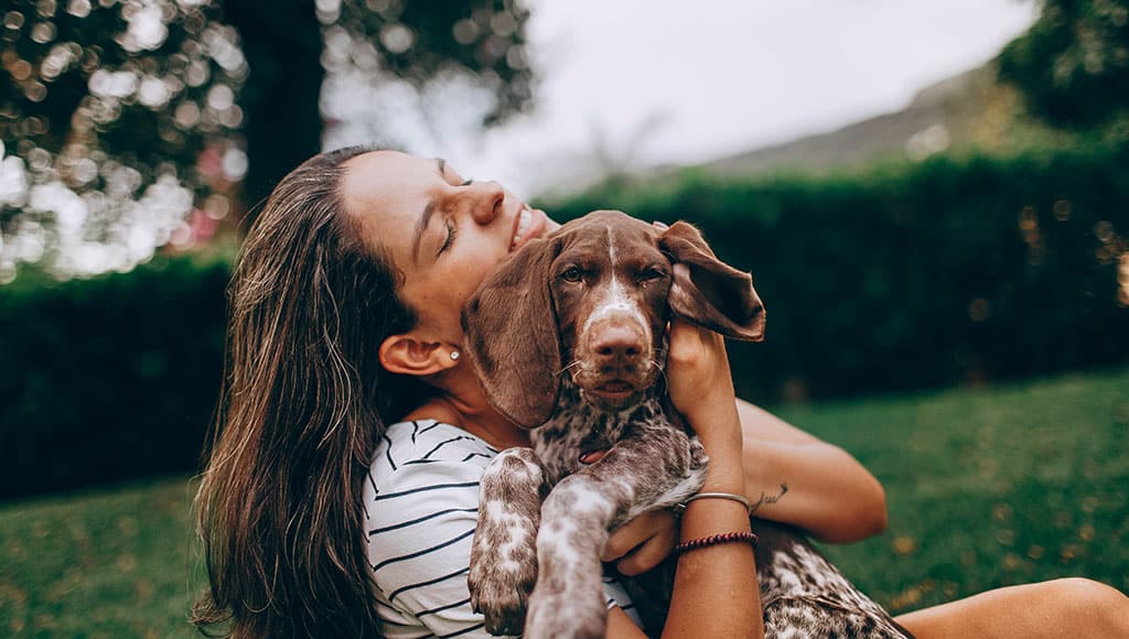 happy woman holding a dog