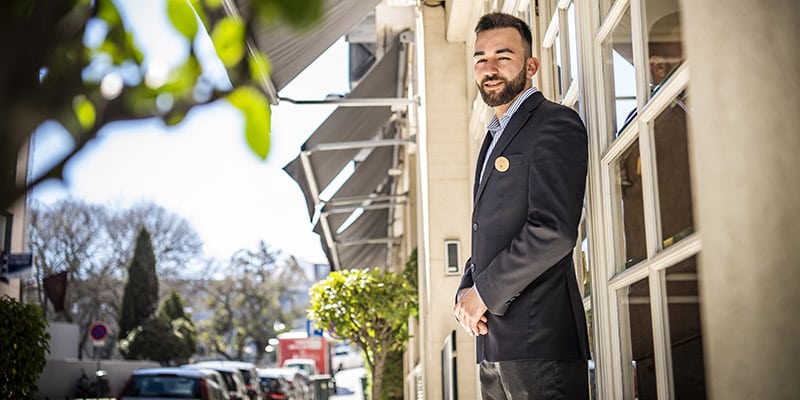 Concierge smiling at the entrance of one of the Lisbon Heritage Hotels units