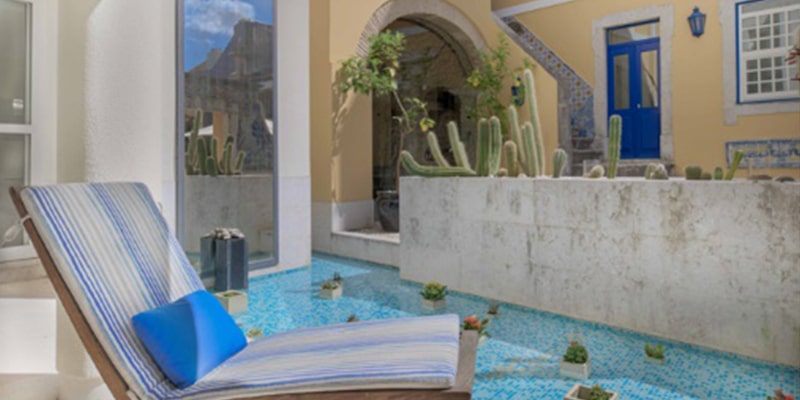 View of the outside of one of the Lisbon Heritage Hotels|The logo for the Experts’ Choice Awards by TripExpert received by the 5 units of the Lisbon Heritage Hotels