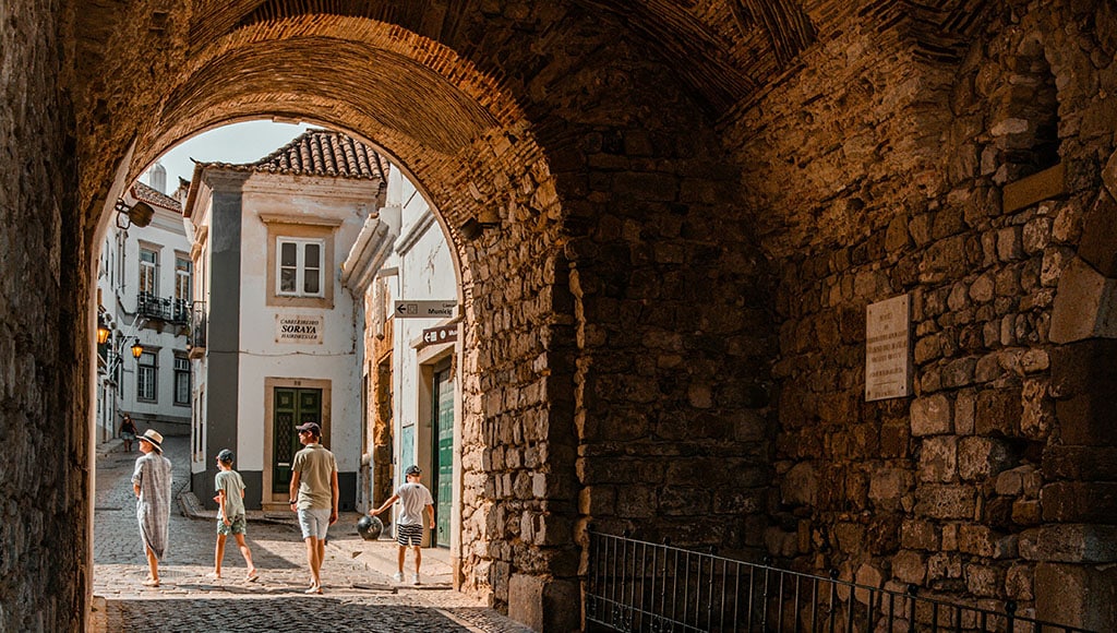 young family walking in historical Portugal town