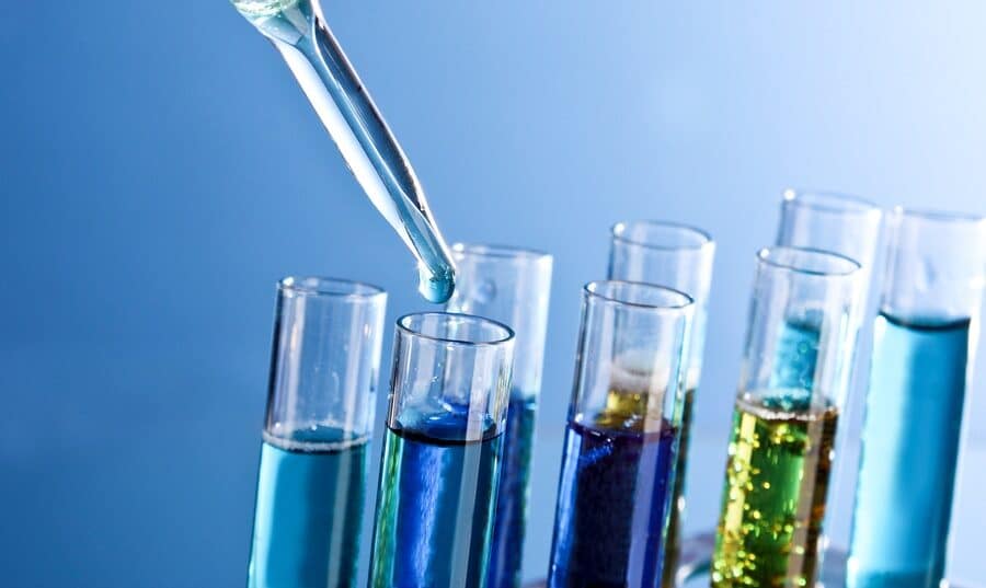 Test tubes closeup on blue background. Drops from test stick