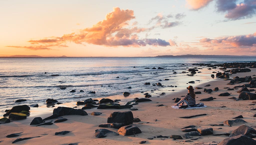 person sitting on the beach