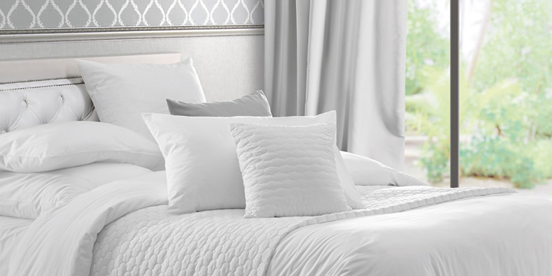 Partial image of a bed prepared to withstand the colder winter months|Partial photo of a mattress with a latex memory foam topper with Tencel covers|Partial image of a quilted mattress protector on a bed|Winter warmth