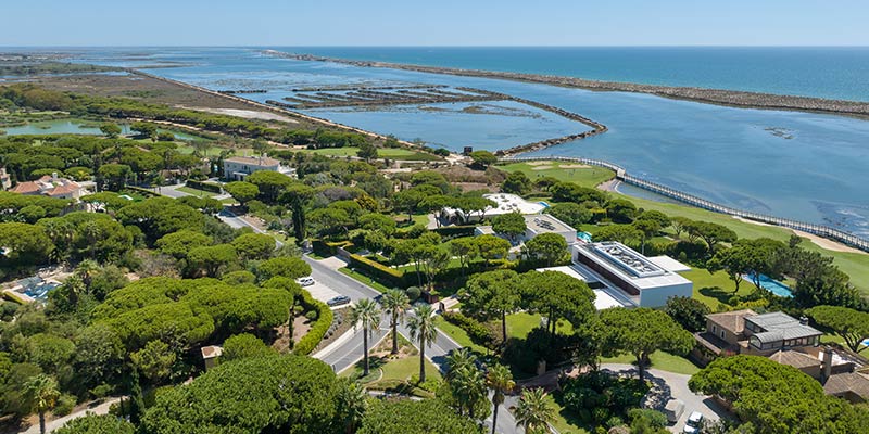 Aerial view over part of Quinta do Lago - a luxury real estate destination|Outside view of the One Select Properties office for property sales