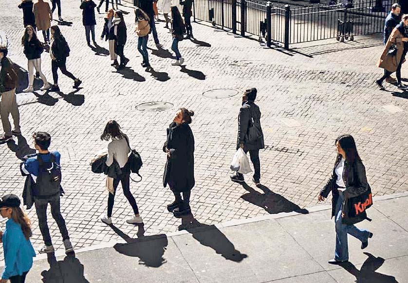 people in the streets|young man looking a phone|homeless person