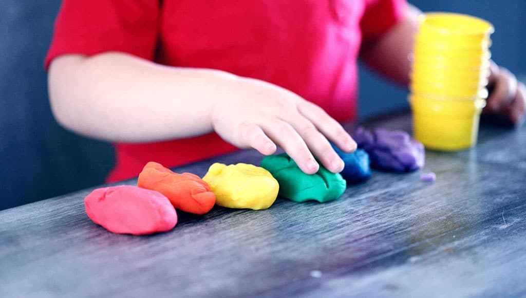 child playing with coloured plasticine